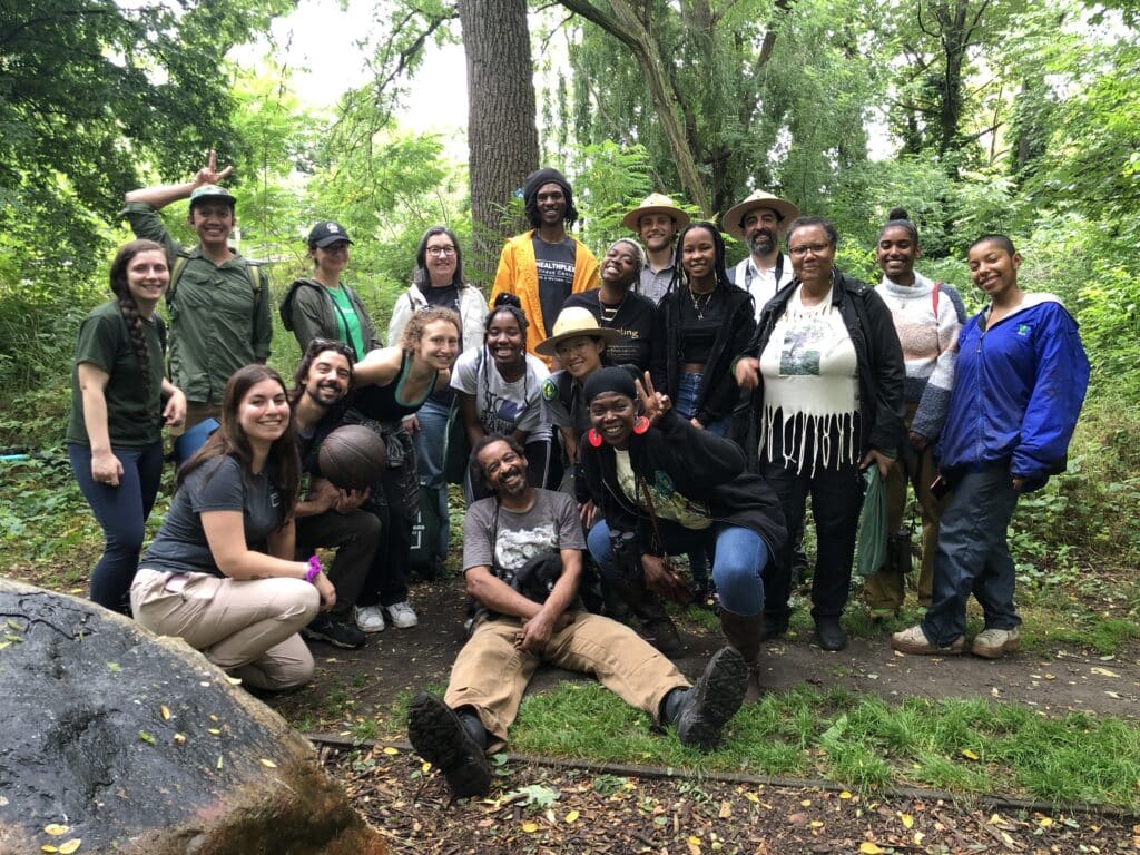 a group of volunteers smiling in forest