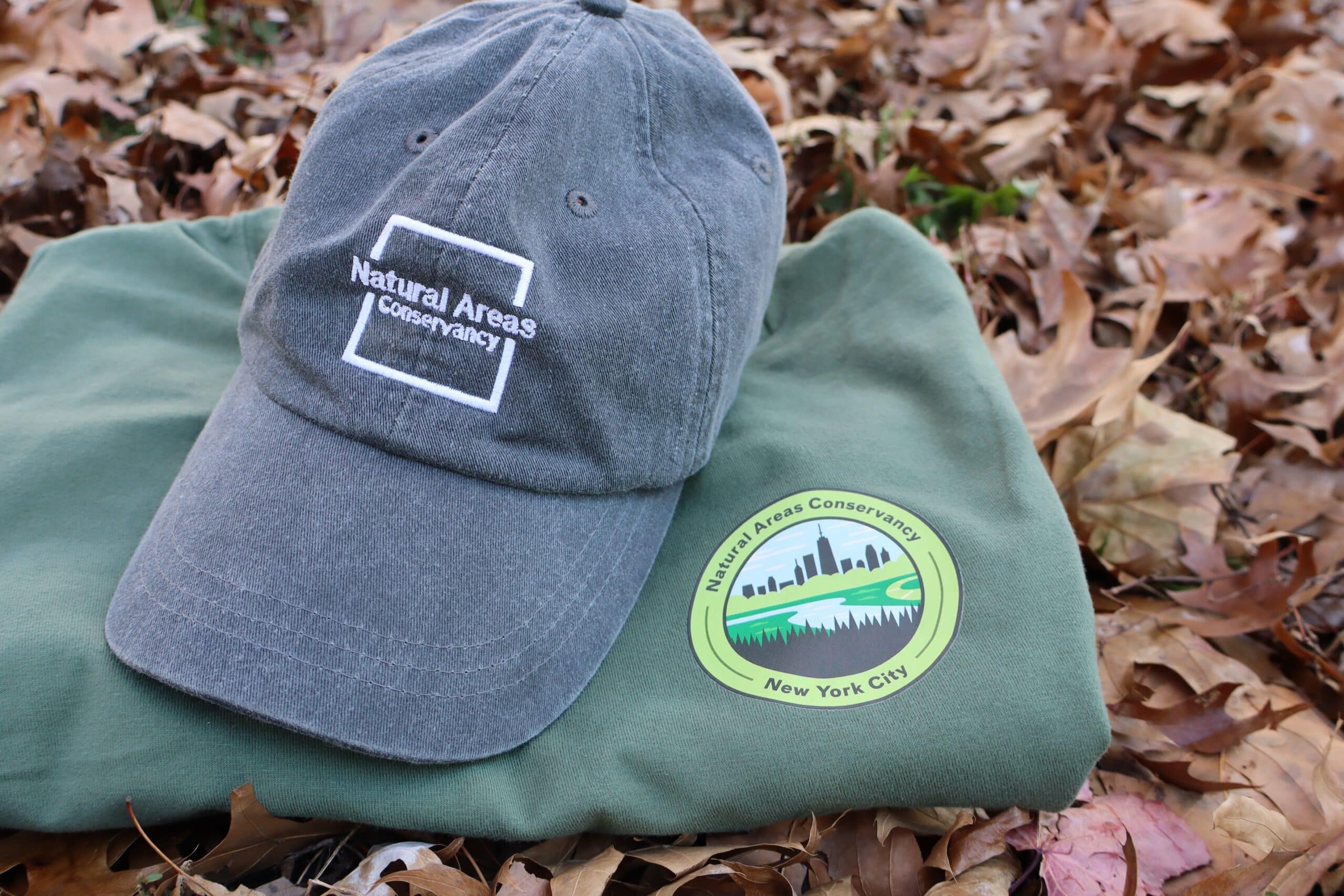 hat and t shirt on bed of fall leaves