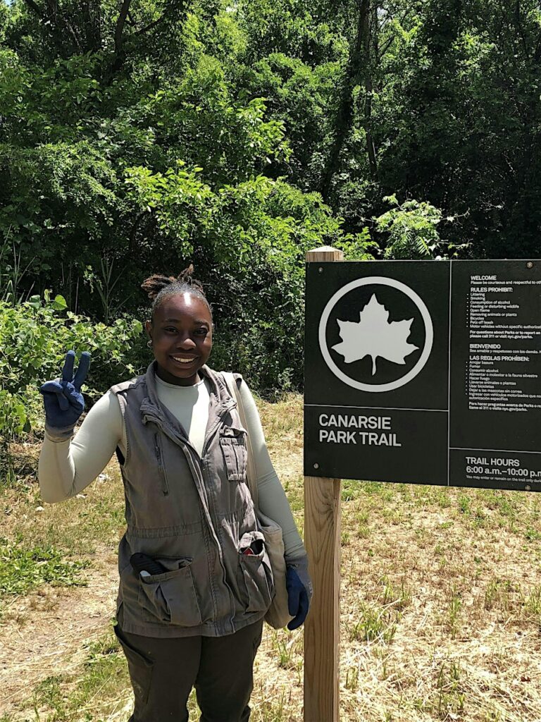 girl infront of park sign