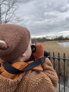 Child holding binoculars