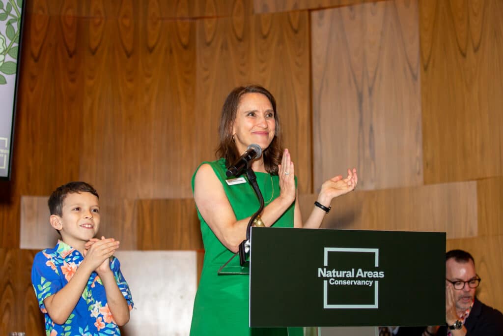 Sarah standing at podium